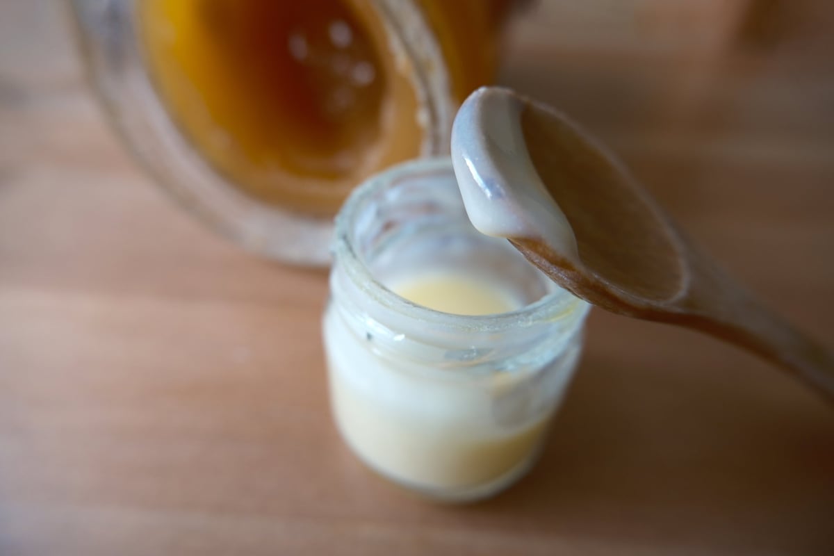 Royal jelly in a little jar. It's also called bee milk, secretion that is used in the nutrition of larvae and adult queens.