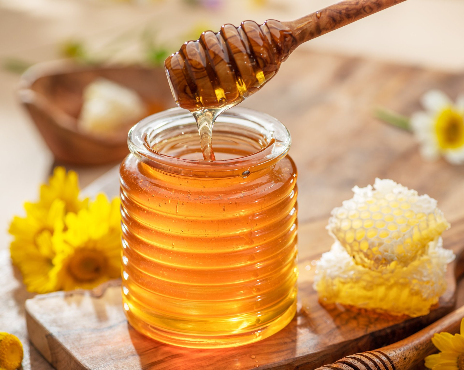 Natural organic honey in glass jar with honeycombs